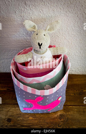 Knitted Easter Bunny in a selection of fun tote bags Stock Photo