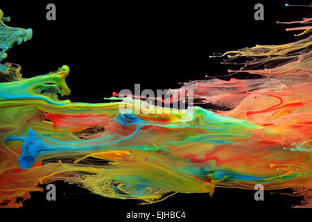 Colorful ink swirling through water Stock Photo