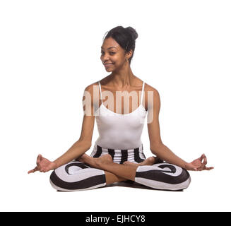 Portrait of young woman meditating in pose of lotus in isolation Stock Photo