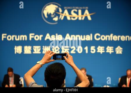 (150327) -- BOAO, March 27, 2015 (Xinhua) -- A guest takes photos with mobile phone at a sub-forum with the theme of 'The Other Side of Big Data' during the 2015 Boao Forum for Asia (BFA) in Boao, south China's Hainan Province, March 27, 2015. (Xinhua/Guo Cheng) (mt) Stock Photo