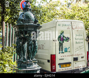 Bronze fountain and garden company van outside flower market in Paris, France Stock Photo