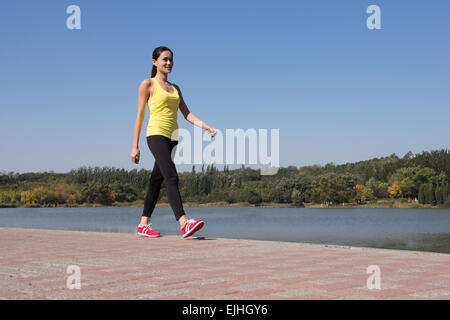 Young woman exercising in park Stock Photo
