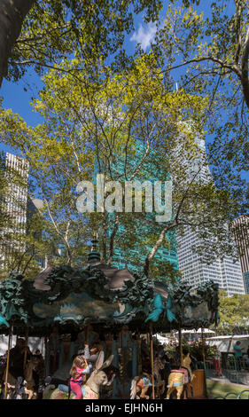 Young girl on carousel in Bryant Park, New York City, USA Stock Photo