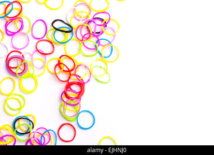 Small round colorful rubber bands for making rainbow loom bracelets isolated on white Stock Photo