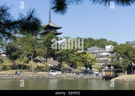 Japanese pagoda tower of Kofukuji temple in Nara, Japan reflected in the waters of Sarusawa Pond on a sunny day Stock Photo