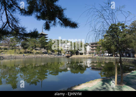 Japanese pagoda tower of Kofukuji temple in Nara, Japan reflected in the waters of Sarusawa Pond on a sunny day Stock Photo