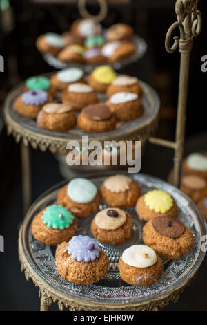 Cream puffs on dishes, Odette pastry shop, Paris, France Stock Photo