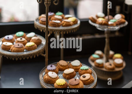 Cream puffs on dishes, Odette pastry shop, Paris, France Stock Photo