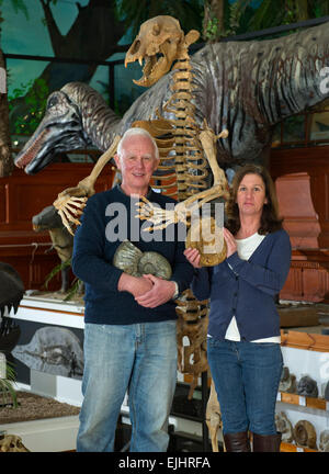 Dinosaurland Fossil Museum in Lyme Regis,Dorset,UK with owners Steve & Jenny Davies with a fossilised cave bear, mamouth tusks and ammonites. Stock Photo