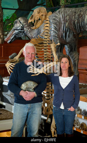 Dinosaurland Fossil Museum in Lyme Regis,Dorset,UK with owners Steve & Jenny Davies with a fossilised cave bear, mamouth tusks and ammonites. Stock Photo