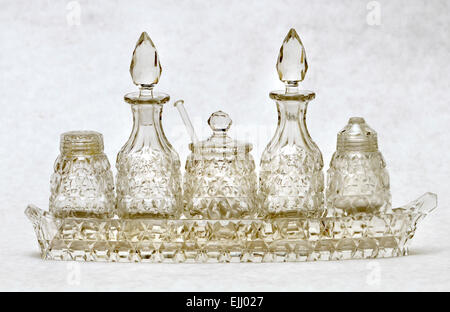 Cut glass cruet set with salt, pepper, mustard, oil and dressing pots Stock Photo