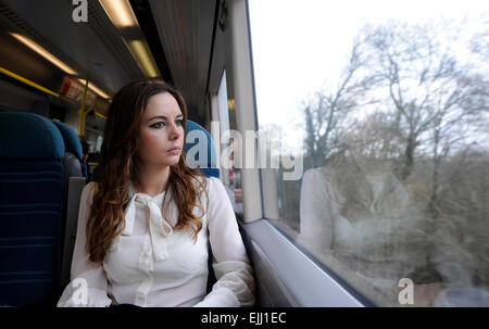 Brighton Sussex UK - Young woman travelling on a Southern Rail train from Brighton to London Stock Photo