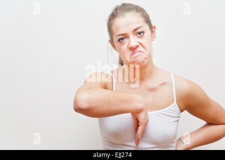 young woman doing an Italian hand gesture meaning she hates you Stock Photo