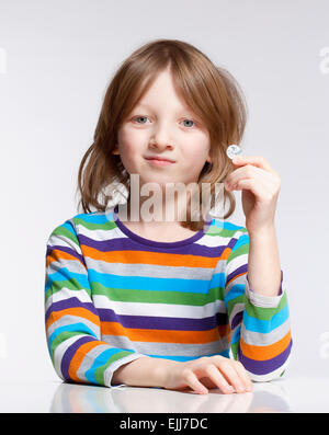 Boy with Blond Hair Holding up a Coin