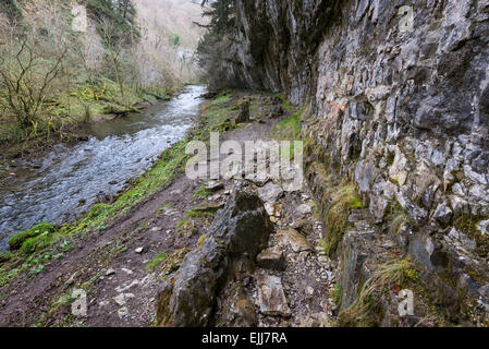 Dramatic limestone cliff overhanging the river Wye in Chee Dale, Derbyshire. Stock Photo