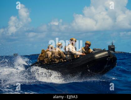 US Marine Reconnaissance special operation soldiers pull away from the guided-missile submarine USS Michigan after a small boat deployment March 24, 2015 in Apra Harbor, Guam. Stock Photo