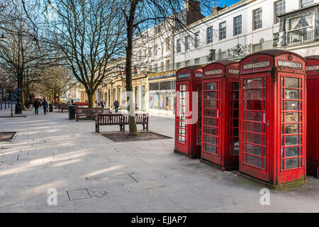 Traditional red telephone boxes on the Promenade in Cheltenham, Gloucestershire Stock Photo