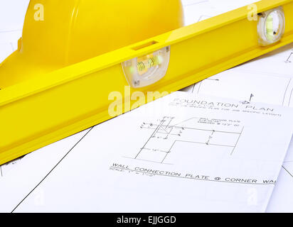 A set of blueprints with hardhat and level Stock Photo