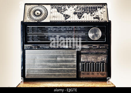 Old international dial radio isolated over white background, placed on wooden surface Stock Photo