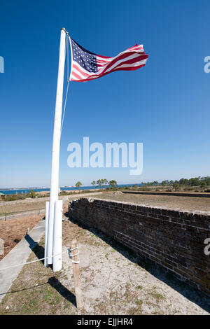Flag flying over historic Fort Pickens on Santa Rosa Island in Pensacola, Florida. Stock Photo