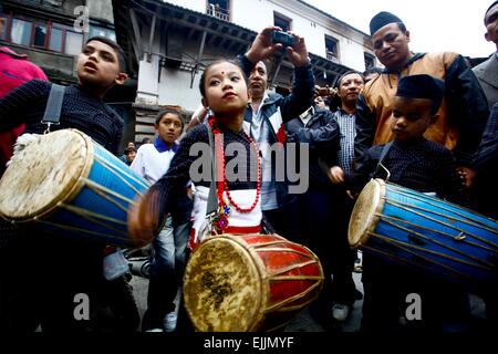 Kathmandu, Nepal. 27th Mar, 2015. Devotees play traditional instruments to mark the beginning of Seto Machhindranath Chariot festival in Kathmandu, Nepal, March 27, 2015. Rato Machhindranath was known as the god of rain and both Hindus and Buddhists worship Machhindranath for good rain to prevent drought during the rice harvest season. Credit:  Pratap Thapa/Xinhua/Alamy Live News Stock Photo