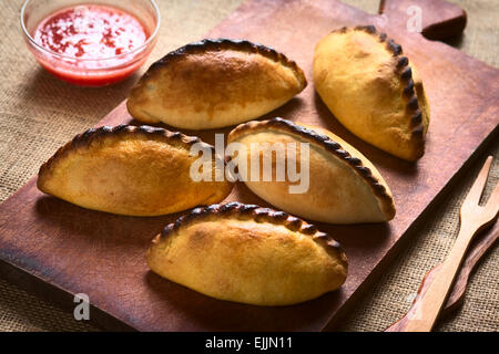 Traditional Bolivian savory pastries called Saltena filled with thick meat stew, which is a popular street snack in Bolivia Stock Photo