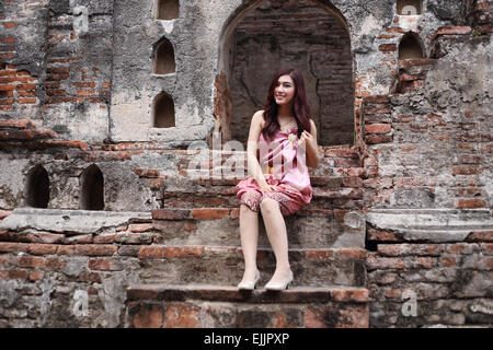 Female in Thai traditional dress at  historical park Stock Photo