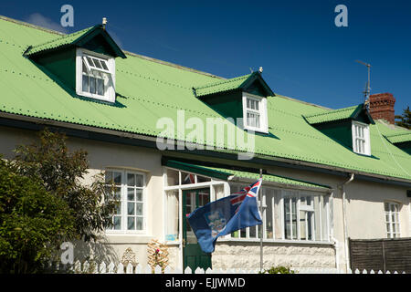 Falklands, Port Stanley, Falkland Islands flag flying outside green roofed house Stock Photo