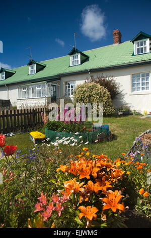 Falklands, Port Stanley, Falkland Islands floral front garden outside green roofed house Stock Photo