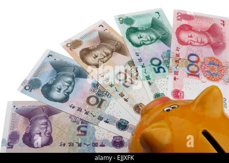 Piggy bank and Chinese money (RMB). 100, 50, 20, 10 and 5 RMB note on a white background. Stock Photo