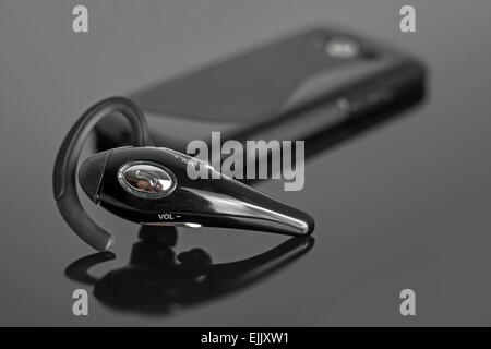 Close-up of mobile handsfree bluetooth device. Stock Photo