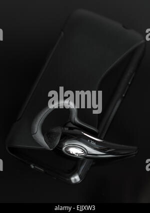 Close-up of mobile handsfree bluetooth device. Stock Photo