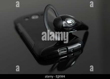 Close-up of mobile handsfree bluetooth device. Stock Photo