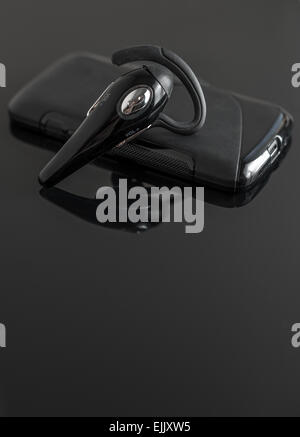 Close-up of mobile handsfree bluetooth device. Stock Photo