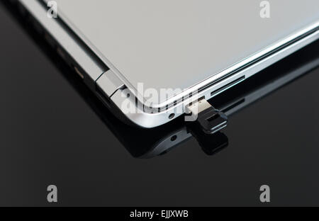 Usb flash drive connected to laptop. Stock Photo