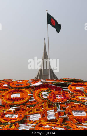 Covered with flowers as people pay tribute in front the National Monument for the Martyrs of the Liberation War of Bangladesh in Savar , DHAKA Stock Photo