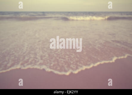 Waves on a beach. In the foreground a thin frothy wave recedes over the sand. Tranquillity. Designed to work with text overlays. Stock Photo