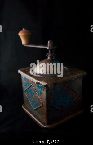 Old manual coffee grinder isolated over black background Stock Photo