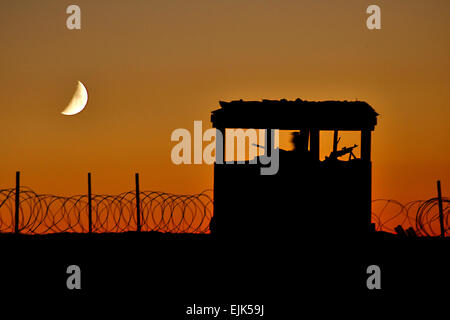 A Soldier mans a security outpost at a construction site. Active duty and reserve component Seabees assigned to Naval Mobile Construction Battalions 40, 18 and 26 secure and fortify a remote combat outpost on the eastern edge of Khavejeh Molk, Afganistan. The village is located approximately 25 miles north of Kandahar and is being used as a patrol base for the U.S. Army 1st Battalion, 66th Armored Regiment. Combined efforts by joint forces will restrict movement of Taliban insurgents and help secure self-governing efforts in Afghanistan.  Chief Mass Communication Specialist Michael B. Watkins Stock Photo