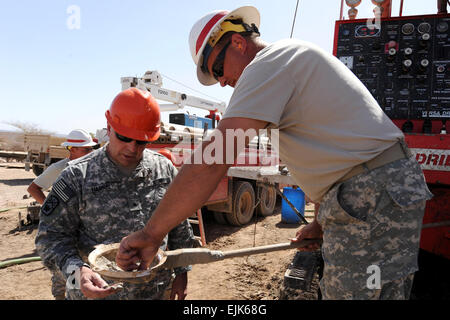 U.S. Army Brig. Gen. Robert A. Harris left, Commander, 194th Engineer Brigade 194 EB and Sgt. Roy Hayes inspect soil consistency while drilling a well in Dikhil, Djibouti, Feb. 20, 2009.  Brig. Gen. Harris was on a five-day trip to Djibouti to visit his troops stationed here. Sgt. Hayes and the rest of the 775th Well Drilling Detachment fall under the 194 EB, a part of the Tennessee Army National Guard. The detachment is deployed to Africa in support of Combined Joint Task Force-Horn of Africa, the primary mission of which is to help Africans solve African challenges.  U.S. Air Force  Staff Sg Stock Photo