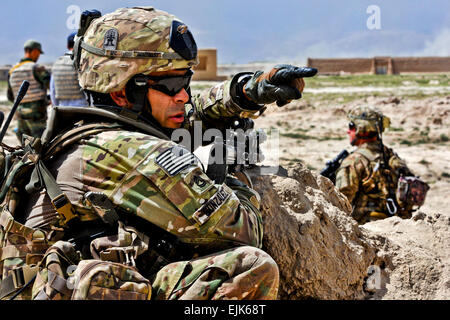 U.S. Army Sgt. 1st Class Fernando Gonzalez, 509th Infantry Regiment, 4th Brigade Combat Team Airborne, 25th Infantry Division directs the movements of his platoon outside Combat Outpost Zormat, May 30.  Spc. Eric-James Estrada Stock Photo