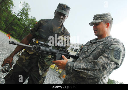 Armed Forces of Liberia Maj. Andrew Wleh and Capt. Ryan Gamston, commander of B Company, 2nd Battalion, 19th Infantry Regiment, discuss marksmanship training during Wleh's visit. He was part of a three-member Liberian delegation to the U.S. to learn more about how to train the new army their country is building to take over security in the country when the U.N. mission in Liberia pulls out in the next few years.          Liberian delegation visits Fort Benning  /-news/2009/08/06/25591-liberian-delegation-visits-fort-benning/ Stock Photo