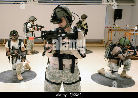 U.S. Army Soldiers, assigned to 412th Aviation Support Battalion, conduct training using the Dismounted Soldier Training System DSTS at the 7th Army Joint Multinational Training Command JMTC at Grafenwoehr, Germany, Dec. 11, 2013. The DSTS is the first fully-immersive virtual simulation for infantry, and one of several virtual training systems available to U.S., partnered and allied forces in Europe.  Visual Information Specialist Markus Rauchenberger/released Stock Photo