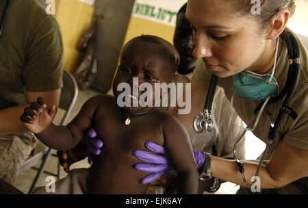 U.S. Army Sgt. Catherine Olivarez, a medic from the 354th Civil Affairs CA Brigade, Special Functioning Team, Combined Joint Task Force- Horn of Africa looks over a toddler during a Medical Civil Action Program MEDCAP at a village school in Goubetto Village, Djibouti March 30, 2008. U.S. Army Soldiers from the 354th Civil Affairs CA Brigade, Special Functioning Team, Combined Joint Task Force- Horn of Africa and the Marines and Sailors from the 11th MEU are working together in support of the CA MEDCAP mission.  Tech. Sgt. Jeremy T. Lock Stock Photo