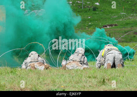 U.S. paratroopers assigned to Able Company, 2nd Battalion, 503rd Infantry Regiment, 173rd Infantry Brigade Combat Team Airborne, prepare to breach a perimeter using explosives during a live fire exercise, a part of exercise Rock Proof in Postonja, Slovenia,  April 28, 2014. Sky Soldiers are here for a two week training exercise with their partners from the Slovenian army’s 10th Battalion. photo by U.S. Army Staff Sgt. Pablo N. Piedra / released Stock Photo