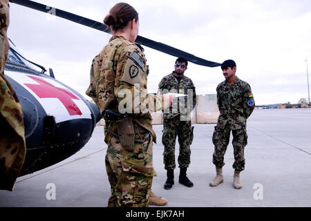 Capt. Margaret Larson, Executive Officer, Company C, 3rd Battalion, 25th Aviation Regiment, Task Force Hammerhead, 25th Combat Aviation Brigade, speaks about the flight medics from the Kandahar Air Wing and their accomplishments during the flight medic training they completed with C/3-25 AVN on Kandahar Airfield, Afghanistan, Nov. 28. Stock Photo