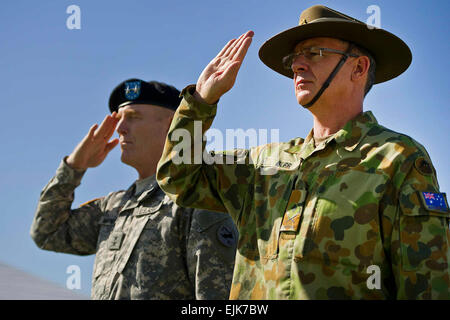 Maj. Gen. Roger F. Mathews Deputy Commanding General U.S. Army, Pacific USARPAC and Australian Defense Force Maj. Gen. Richard M. Burr, Headquarters U.S. Army Pacific Deputy Commanding General of Operations salute as the US and Australian National Anthems are played during a Jan. 17, 2013 Deputy Commanding General flying V Ceremony at the Historic Palm Circle on Fort Shafter, Honolulu, Hawaii. The ceremony held to welcome Burr and his family as the first foreign military officer to be assigned at this level of leadership in the U.S. Army. Burr’s appointment as the USARPAC Deputy Commanding Gen Stock Photo