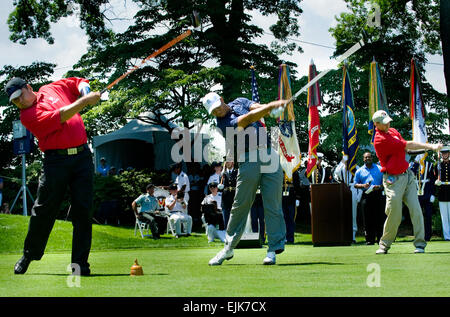 From left to right Staff Sgt. Ramon Padilla, Tiger Woods, and Maj. Ken Dwyer hit the ceremonial first shot at the opening ceremony of the Earl Woods Pro-am golf tournament at the Congressional Country Club, Bethesda, Md., July 1. Dwyer is an injured Soldier assigned to the 3rd Special Forces Group in Fort Bragg, N.C. Padilla is also an injured Soldier, who is assigned to Walter Reed Army Medical Center.  Photo credit: Master Sgt. Cecilio Ricardo.           Tiger Woods honors troops  /-news/2009/07/02/23804-tiger-woods-honors-troops/?ref=home-headline-title0 Stock Photo