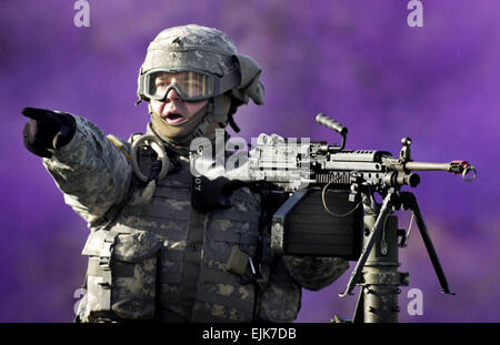 U.S. Army Sgt. Edgar Brown shouts to a gunner on his right during a simulated convoy attack at Fort Dix, N.J., on May 3, 2007.  Brown's unit is being trained by the 1st Army Division Public Affairs in preparation for a mission in support of U.S. Army Central Command.  Brown is assigned to the 131st Mobile Public Affairs Detachment.   Staff Sgt. Russel Lee Klika, U.S. Army. Stock Photo