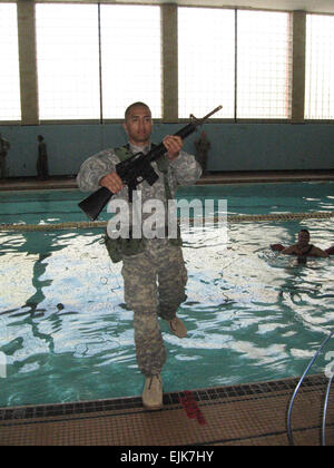 A U.S. Army officer candidate from Bravo Company, 3rd Battailon, 11th Infantry Regiment enters a swimming pool during the combat water survival portion of Officer Candidate School March 14, 2008, at Fort Benning, Ga.  Kenneth R. Toole Stock Photo